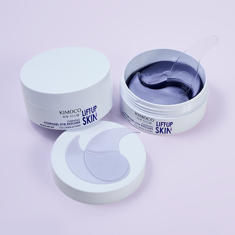 Zamknięty biały pojemnik "Kimoco Lift-Up Skin Firming Hydrogel Eye Patches", na jasnofioletowym tle.