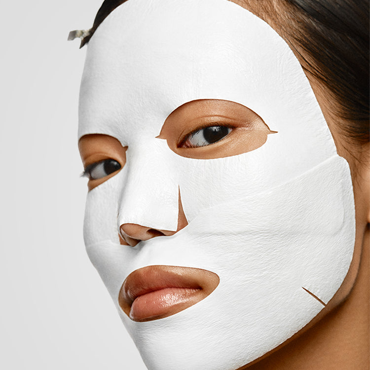 Różowe opakowanie z zawieszką "Kimoco Lift-Up Skin Royal Cream Lock Rejuvenation Mask" z ilustracją maseczki w płachcie, na jasnym tle.