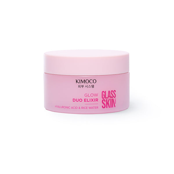 Zdjęcie na białym tle: po środku zamknięty różowy słoiczek "Kimoco Glass Skin Glow Duo Elixir" z opisem "Hyaluronic Acid & Rice Water".
