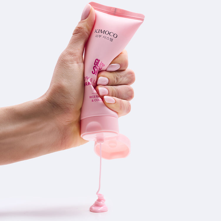 Różowy tubka kosmetyku Kimoco Glass Skin Glow & Lift Wrapping Mask z ekstraktem ryżowym i kolagenem, na białym tle.