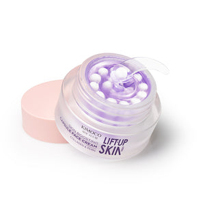 Otwarty słoiczek Kimoco Lift-Up Skin Capsule Face Cream z fioletowymi kapsułkami, z lewej różowa zakrętka, na białym tle.